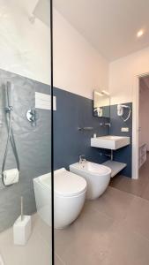a bathroom with a tub and a sink and a toilet at Tevergad Premium Rooms in Terrasini