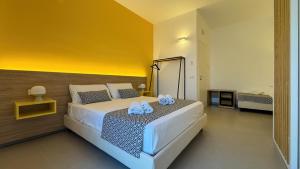 a bedroom with a bed with two towels on it at Tevergad Premium Rooms in Terrasini