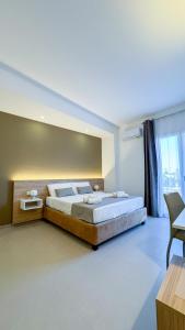 a bedroom with a large bed and a large window at Tevergad Premium Rooms in Terrasini +55 photos