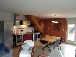 a kitchen and dining room with a table and chairs at Gîte L'establou Lissacoise in Lissac-sur-Couze