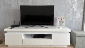 A television and/or entertainment centre at Apartments Paradise Lloret