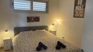 A bed or beds in a room at Apartments Paradise Lloret