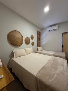 a bedroom with two beds in a room at Casita Beach House in Itarema +50 photos
