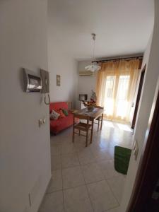a living room with a red couch and a table at Caterina in Isola delle Femmine