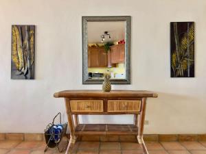 a dressing table with a mirror on a wall at Puerto Nuevo Villa Olas 2BR 2BA with pool in Raulis +17 photos