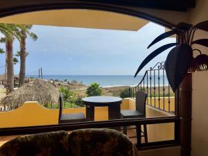 a balcony with a table and a view of the ocean at Puerto Nuevo Villa Olas 2BR 2BA with pool in Raulis