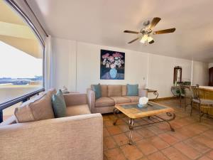 a living room with a couch and a table at Puerto Nuevo Surf Villa Margarita 2BR with pool in Raulis