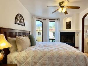 a bedroom with a bed with a ceiling fan and a fireplace at Puerto Nuevo Surf Villa Margarita 2BR with pool in Raulis