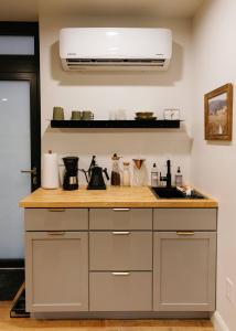 a kitchen counter with a sink and a microwave at Modern Mirror Home w/ Hot-tub | “Glass House” #2 in High Falls +27 photos