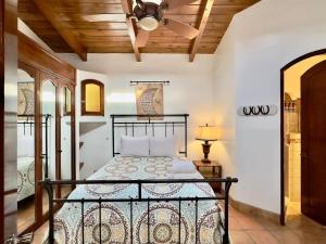 a bedroom with a bed and a ceiling fan at Puerto Nuevo Surf Villa Tranquilidad 2BR with pool in Raulis