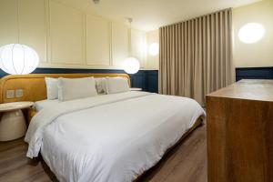 Ένα ή περισσότερα κρεβάτια σε δωμάτιο στο Hotel Acqua Medellín