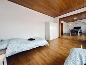 a bedroom with two beds and a wooden floor at sleepWELL-Horstmar II Zentral & Komfort in Horstmar