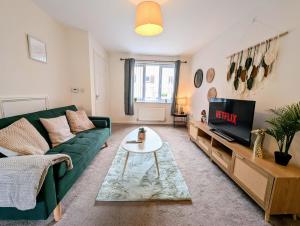 un soggiorno con divano verde e TV di Steps from O2 Apollo, Ox road a Manchester