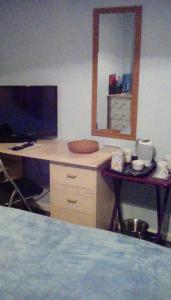a desk with a computer and a mirror in a room at Bed & Breakfast Only - not 24 hour lodging - Truro, Cornwall - free parking in Truro