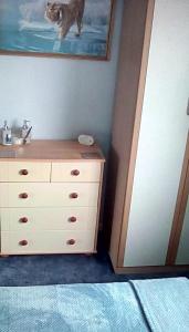 a bedroom with a dresser with a sink and a painting at Bed & Breakfast Only - not 24 hour lodging - Truro, Cornwall - free parking in Truro