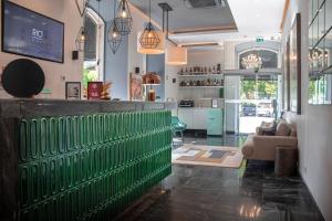 a bar with a green fence in a room at Rio Art Hotel in Setúbal