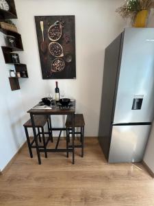 a kitchen with a table and a refrigerator at Seabreeze Ultracentral - NeverSea Beach in Constanţa