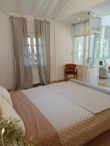 a bedroom with a large bed in a room at Tranquil Haven with Private Pool in Trýgonas +23 photos