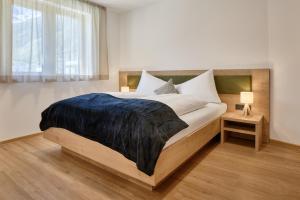 Postel nebo postele na pokoji v ubytování Das Refugium Mountain Apartment Ötztal - Längenfeld