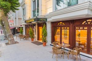 a street with tables and chairs in front of a building at Grand Naki Hotel in Istanbul