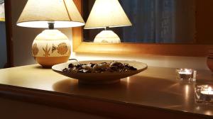 a bowl of shells on a table with two lamps at Phalanthos B&B in Leporano +23 photos