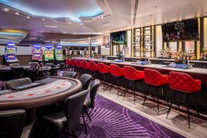 a bar with red seats in a casino at Harrah's Gulf Coast Hotel & Casino in Biloxi