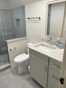 a bathroom with a toilet and a sink and a shower at 1515 Deer Pointe Villa in Seabrook Island +27 photos