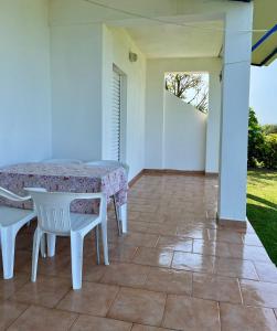 a white table and chairs on a patio at Physis Seaside Living in Preveza