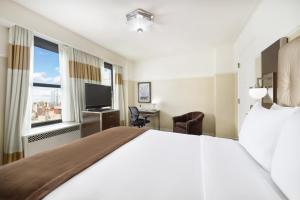 a hotel room with a large bed and a window at New Yorker by Lotte Hotels in New York