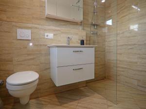 a bathroom with a toilet and a sink and a shower at Reihenhaus am Gardersee in Garden +33 photos