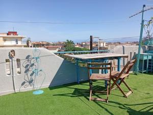 a table and a chair sitting on a roof at Kiato Rooftop Garden Apartment in Kiaton