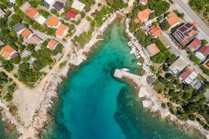 an aerial view of a beach with houses and the water at Apartments Bono in Karlobag