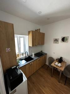 a kitchen with wooden cabinets and a sink and a table at Moin Apartment in Sibiu +29 photos