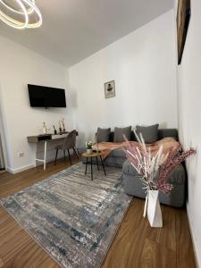 a living room with a couch and a table at Moin Apartment in Sibiu