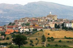 a town on a hill with mountains in the background at PIAZZA SANTANGELO - Home - in Busso