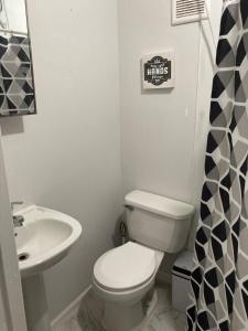 a bathroom with a white toilet and a sink at Casa Vagon Villa Janer in San Lorenzo +56 photos