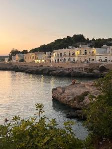 a group of buildings on the shore of a body of water at A Casa da Maria in Melissano