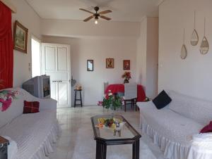 a living room with two white couches and a table at Kiato Rooftop Garden Apartment in Kiaton