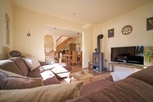 a living room with a couch and a tv at Ferienhaus am Spiegelberg in Lemgo in Lemgo +49 photos