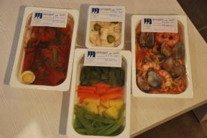 three plastic containers filled with different types of food at Aparthotel Meseguer in Alcañiz