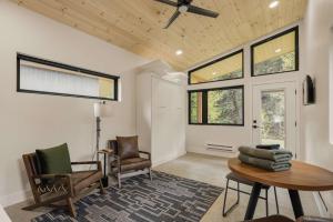 a living room with chairs and a table and windows at Modern Cabin Peaceful Nature Retreat Sleeps 2 in Grant +28 photos