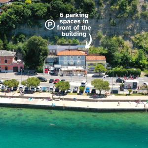 a group of people on a pier next to the water at Blue Pearl Elite Apartments in Piran