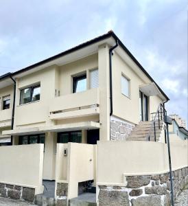 a house with a stone fence in front of it at House Real Companhia 55/53 in Vila Nova de Gaia +19 photos
