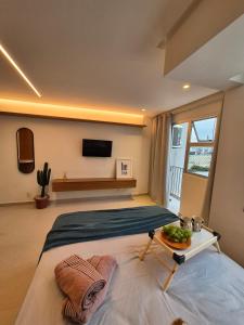 a bedroom with a bed with a tray of food on it at Guaraloft DUBAI Centro de Guarapari in Guarapari