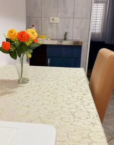 a vase of flowers sitting on a kitchen table at Apartments Mitrovići Miločer in Sveti Stefan