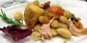 a white plate of food with meat and vegetables at Aparthotel Meseguer in Alcañiz