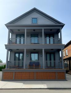 a large house with a large front porch at Brand New Construction! 3 Unit5 Bed Property in Newport