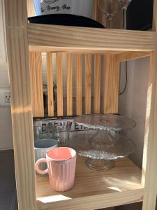 a wooden shelf with a table and cups on it at Quinta los Lopez in Azul