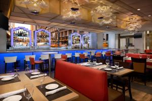 a restaurant with tables and chairs and a bar at New Yorker by Lotte Hotels in New York