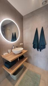 a bathroom with a sink and a mirror at Dulce Tierra - appartement in Zoutelande +38 photos